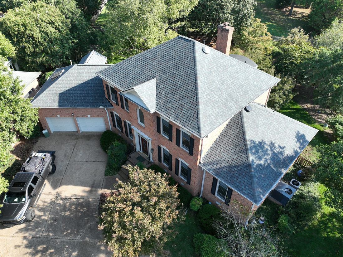 Architectural shingle replacement on a two-story brick colonial, seen from above in Middle Tennessee