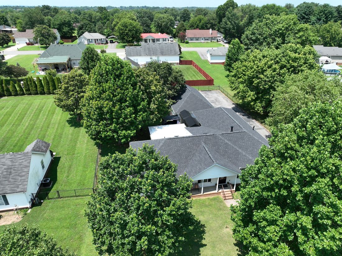 Charcoal shingle replacement on a single-story ranch home surrounded by mature trees in Middle Tennessee